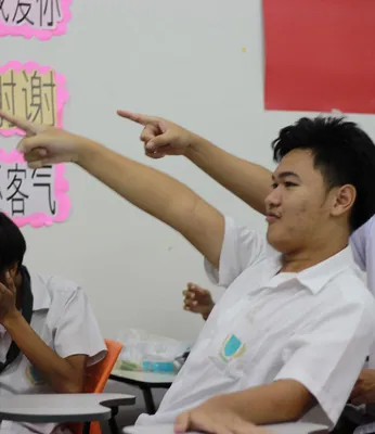 Students practicing Chinese language in pairs and enjoying learning